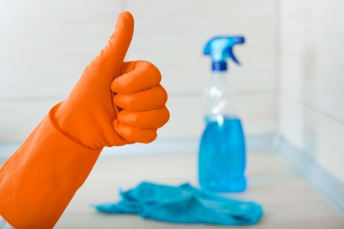A cleaner removing building dust from windows and frames